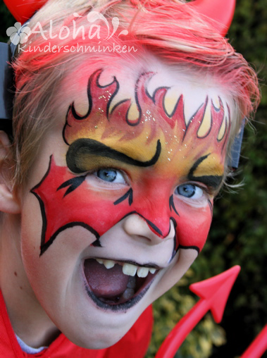 Devil face paint design for Halloween with bold red tones