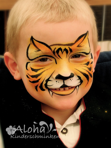 Tiger face painting in bold colours for parties and events