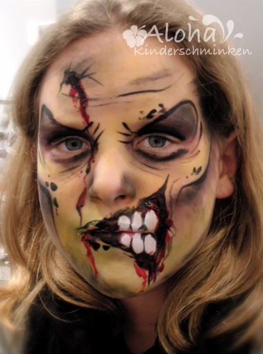 Zombie face painting for Halloween with realistic effects